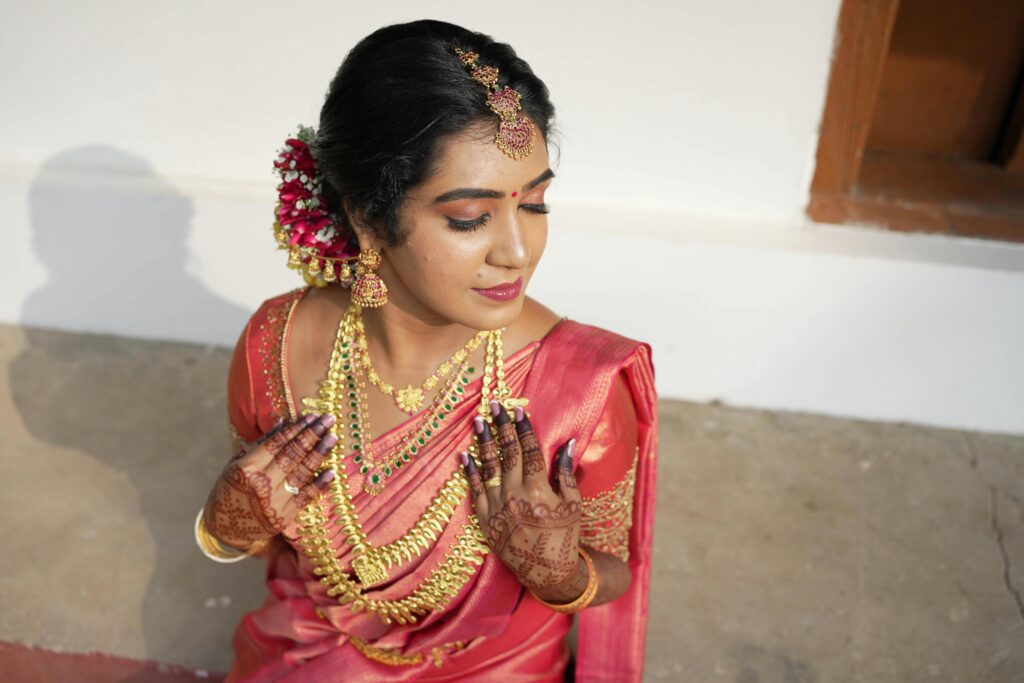 Elegant Indian bride adorned with traditional jewelry and henna for a wedding ceremony.